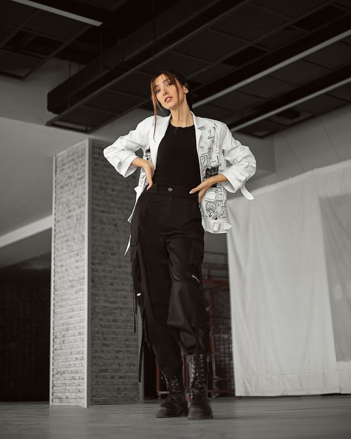 Modern style woman in trendy outfit posing inside an urban setting. Chic and confident vibe.