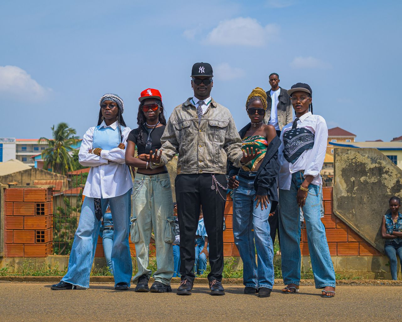 Fashionable young adults posing confidently in an urban outdoor environment with casual streetwear.